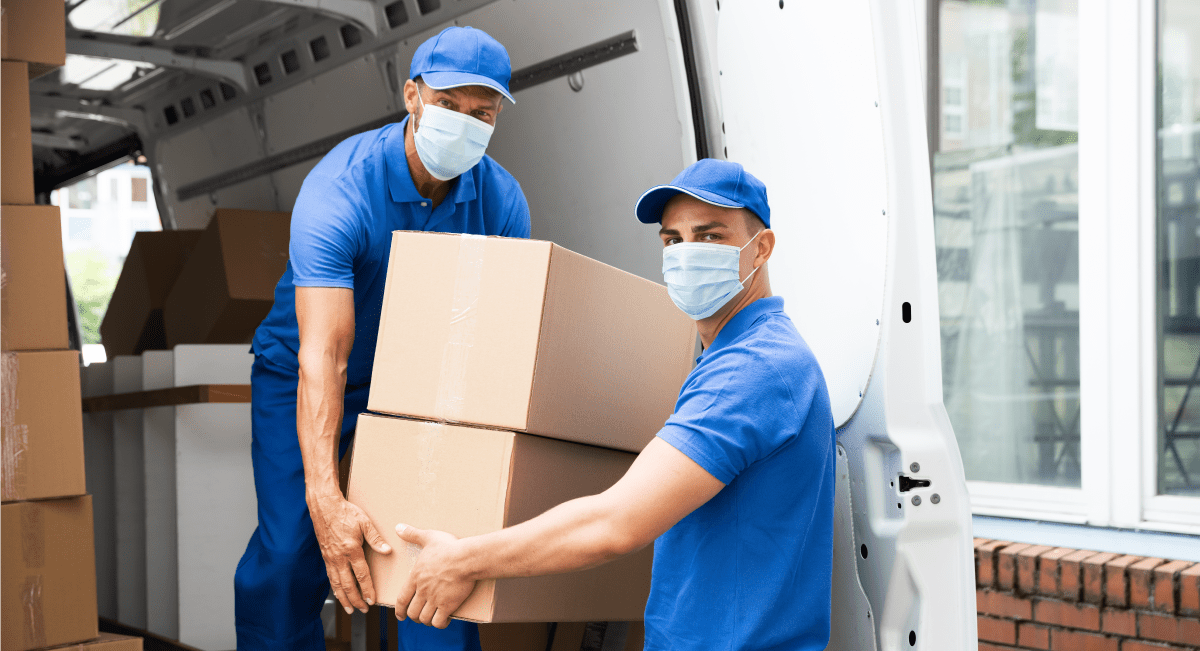 Two diligent employees loading a truck, showcasing the Removal Masters' team's hard work and efficiency.